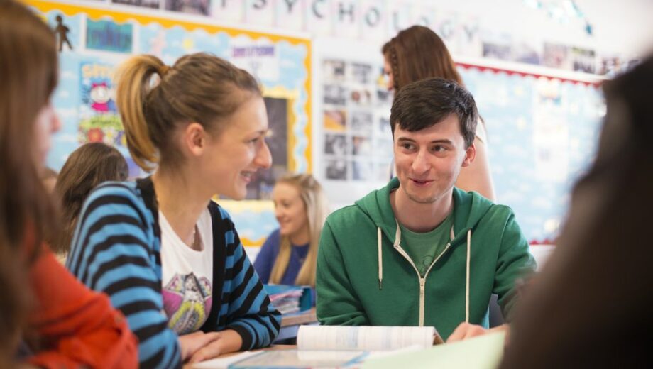 Photo of male and female students in a classroom in st helens college