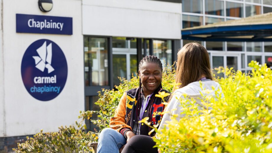 Two students sat outside the Chaplaincy talking