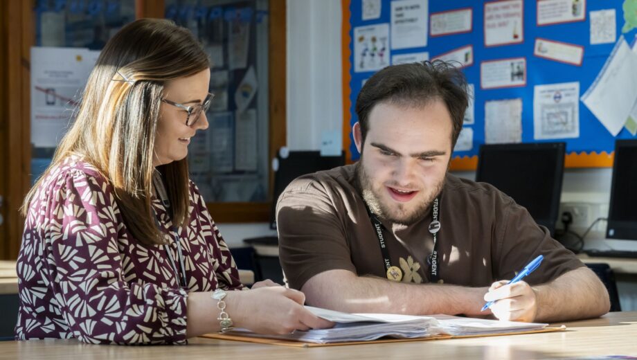 Female Teacher sat with male student
